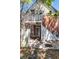 Brick home exterior featuring a second-story deck and an outdoor staircase at 2410 W 36Th Ave, Denver, CO 80211