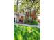 A brick two-story home is beautifully shaded by mature trees, enhancing its curb appeal at 2410 W 36Th Ave, Denver, CO 80211