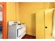 Vintage kitchen showcasing a white oven and yellow storage cabinet against a yellow wall at 2410 W 36Th Ave, Denver, CO 80211