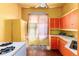 Bright kitchen with colorful cabinetry and a window, waiting for someone to bring it back to life at 2410 W 36Th Ave, Denver, CO 80211