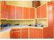 Compact kitchen with red and yellow cabinets, offering a vintage charm, awaiting some renovations at 2410 W 36Th Ave, Denver, CO 80211