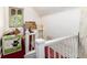 Upstairs hallway features a white railing, boxes, and natural light from a window at 2410 W 36Th Ave, Denver, CO 80211