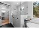 Elegant bathroom with glass shower, marble accents, and a large window at 8006 S Settlers Dr, Morrison, CO 80465