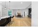 Open concept dining room with hardwood floors and modern light fixture at 8006 S Settlers Dr, Morrison, CO 80465