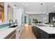 Modern kitchen with white cabinets, an island, and a blue tile backsplash at 8006 S Settlers Dr, Morrison, CO 80465