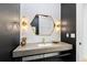 Modern powder room with hexagon mirror and stylish lighting at 8006 S Settlers Dr, Morrison, CO 80465