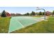 Outdoor community basketball court surrounded by lush green lawns and residential homes at 12554 Hudson Ct, Thornton, CO 80241