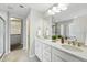 Bathroom featuring dual sinks, white cabinets, and walk-in shower at 12554 Hudson Ct, Thornton, CO 80241