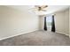 Bedroom featuring plush carpeting, a ceiling fan, and a window with black curtains at 12554 Hudson Ct, Thornton, CO 80241