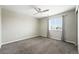 Bedroom featuring plush carpeting, a modern ceiling fan, and a window with gray curtains at 12554 Hudson Ct, Thornton, CO 80241