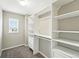 Walk-in closet with custom white shelving and a window for natural light at 12554 Hudson Ct, Thornton, CO 80241