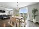 Cozy dining room with dark hardwood floors, a fluffy white rug, and a sliding glass door to the outdoor space at 12554 Hudson Ct, Thornton, CO 80241