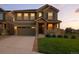Charming two-story home featuring a covered front porch and a well-maintained lawn at 12554 Hudson Ct, Thornton, CO 80241