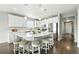 Bright kitchen features a large island with barstool seating, stainless steel appliances, and pendant lighting at 12554 Hudson Ct, Thornton, CO 80241