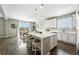 Bright kitchen with white cabinets, a central island, and stainless steel appliances at 12554 Hudson Ct, Thornton, CO 80241