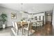 Open-concept kitchen and dining area featuring pendant lighting and a modern design at 12554 Hudson Ct, Thornton, CO 80241