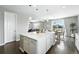 Open concept living: the kitchen features a large island and seamlessly connects to the dining and living areas at 12554 Hudson Ct, Thornton, CO 80241