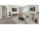 Comfortable living room features neutral walls, TV, and modern decor with plenty of natural light at 12554 Hudson Ct, Thornton, CO 80241