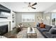 Comfortable living room showcasing a ceiling fan, fireplace, and stylish decor at 12554 Hudson Ct, Thornton, CO 80241