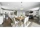 Open-concept living space connecting the kitchen, dining, and living areas for modern living at 12554 Hudson Ct, Thornton, CO 80241