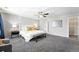 Spacious main bedroom with neutral colors, bench, and ceiling fan at 12554 Hudson Ct, Thornton, CO 80241