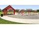 A community playground with swings, slides, and picnic tables under a covered pavilion at 12554 Hudson Ct, Thornton, CO 80241