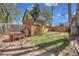 Serene backyard with brick patio, dining area, grill, shed, and a play set, perfect for outdoor entertaining and Gathering fun at 1726 N Lafayette St, Denver, CO 80218