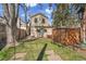 Spacious backyard with a lush green lawn, a shed, and mature trees, perfect for outdoor activities and relaxation at 1726 N Lafayette St, Denver, CO 80218