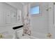 Cozy bathroom with white subway tile, a floral shower curtain, and vintage-style fixtures at 1726 N Lafayette St, Denver, CO 80218