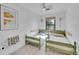 Bright and charming bedroom with twin beds, unique decor, and a ceiling fan, creating a cozy and inviting space at 1726 N Lafayette St, Denver, CO 80218