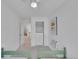 Bright bedroom featuring twin beds, a closet with built-in shelving, and modern decor, offering a cozy and stylish space at 1726 N Lafayette St, Denver, CO 80218