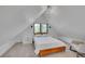 Bright bedroom with an A-frame ceiling, dual sconces, and windows at 1726 N Lafayette St, Denver, CO 80218