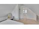 Inviting bedroom with an A-frame ceiling, neutral colors, and cozy seating at 1726 N Lafayette St, Denver, CO 80218