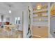 Bright dining area features hardwood floors, a modern light fixture, and unique built in utility storage at 1726 N Lafayette St, Denver, CO 80218