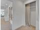 Hallway featuring a mirrored wall, built-in closet, and carpeted floors at 1726 N Lafayette St, Denver, CO 80218