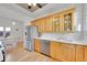 Well-lit kitchen with stainless steel appliances, wood cabinets, marble countertops, and hardwood floors at 1726 N Lafayette St, Denver, CO 80218