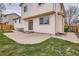 Exterior view of the house with a concrete patio and partially fenced-in yard at 4032 S Lisbon Way, Aurora, CO 80013