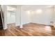 A spacious basement with wood-look flooring, neutral paint and stairs visible to the left at 4032 S Lisbon Way, Aurora, CO 80013