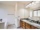 Bright bathroom featuring a double sink vanity, granite countertops and a separate tub at 4032 S Lisbon Way, Aurora, CO 80013