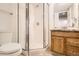 Bright bathroom featuring a glass enclosed shower and a light wood vanity at 4032 S Lisbon Way, Aurora, CO 80013