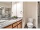 Modern bathroom featuring granite counters, wood cabinets, and a glass enclosed shower at 4032 S Lisbon Way, Aurora, CO 80013