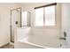 Bathroom features a large bathtub and glass enclosed shower with white tile surround at 4032 S Lisbon Way, Aurora, CO 80013