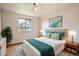 Comfortable bedroom features modern decor, natural lighting, and hardwood flooring at 4032 S Lisbon Way, Aurora, CO 80013