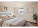 Cozy bedroom features a soft upholstered bed, ceiling fan, and natural light at 4032 S Lisbon Way, Aurora, CO 80013