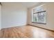 Bright bedroom features hardwood floors and a large arched window offering plenty of natural light at 4032 S Lisbon Way, Aurora, CO 80013