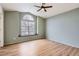 Light and airy bedroom with hardwood floors, large window and fan at 4032 S Lisbon Way, Aurora, CO 80013