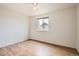 Bedroom with hardwood floors and large window allowing natural light to flow into the room at 4032 S Lisbon Way, Aurora, CO 80013