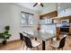 Stylish dining area with modern table, hardwood floors, and natural lighting at 4032 S Lisbon Way, Aurora, CO 80013