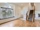 Inviting entryway with hardwood floors, staircase, and large window at 4032 S Lisbon Way, Aurora, CO 80013