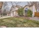 Lovely home exterior showcasing a well-kept lawn, brick accents, and mature landscaping at 4032 S Lisbon Way, Aurora, CO 80013